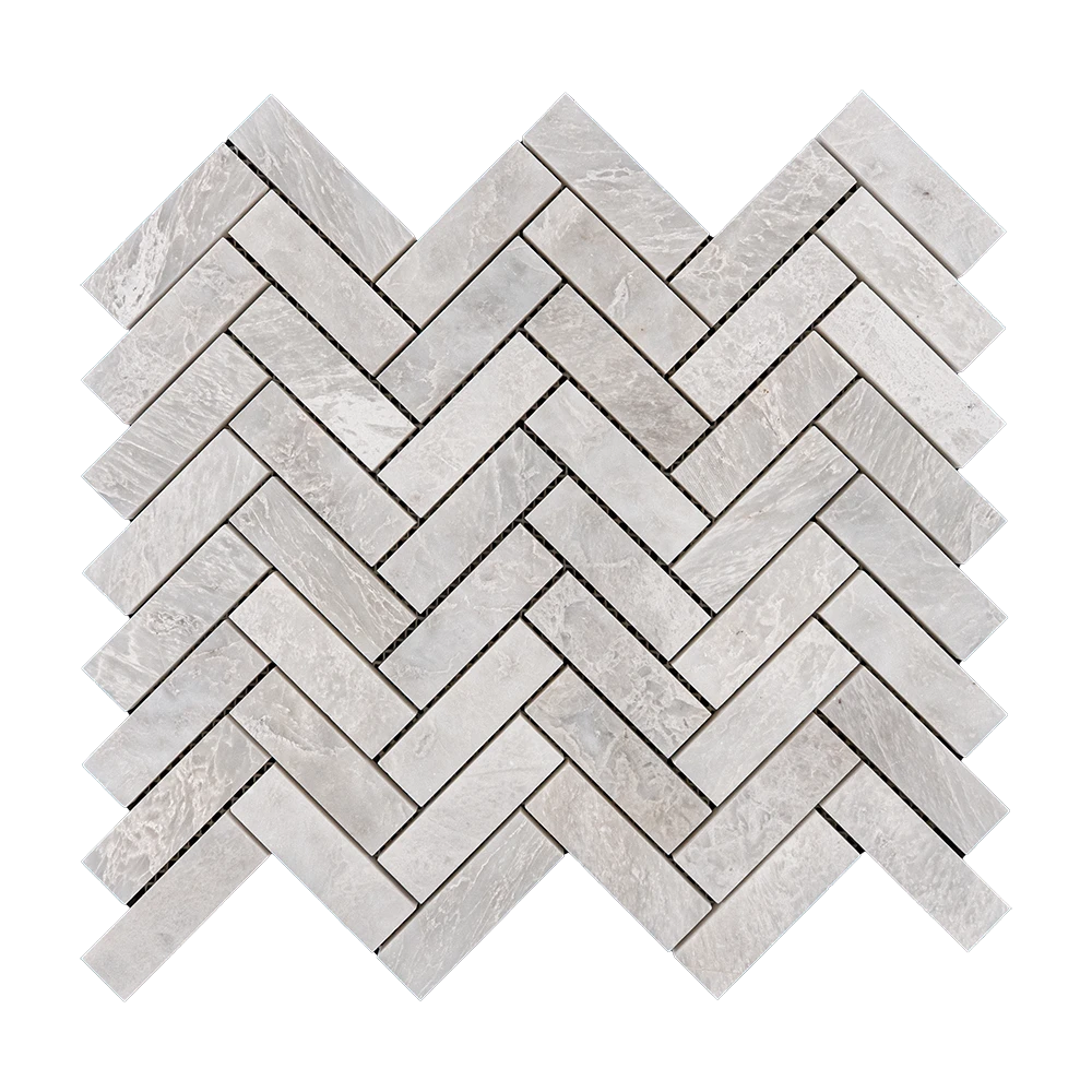 Detailed view of Iceberg Herringbone 1x3 mosaic tiles, showing the natural veining of the white marble and its reflective polished surface.