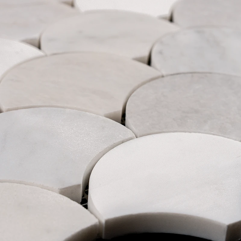 Macro view of polished fish scale marble mosaic tiles made from Dolomite, Iceberg, and Imperial White stone, highlighting curved edges and icy veining texture