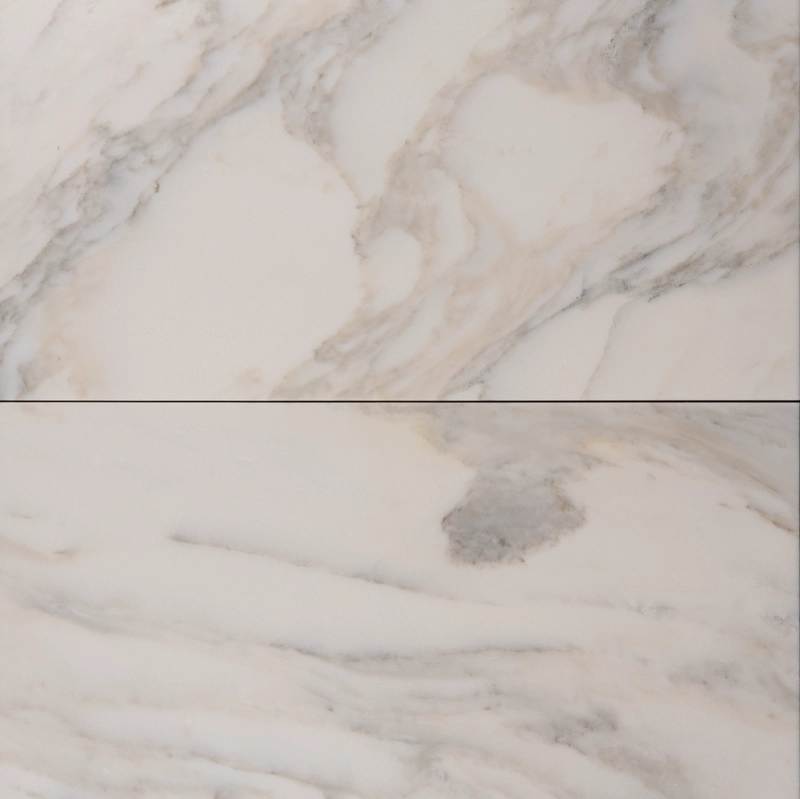 Dual-tile view of Calacatta marble with honed finish, showcasing soft taupe and gray veining.