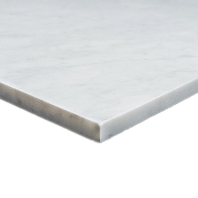 Close-up corner view of the Carrara tile, emphasizing its beveled edge and honed marble surface.