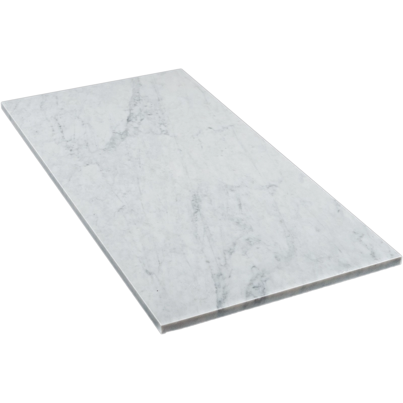 Angled view of the 18"x36" Carrara honed marble tile, displaying its clean lines and natural stone pattern.