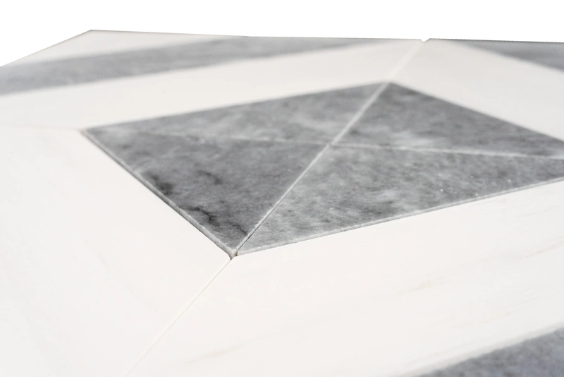 Detailed top-down view of a marble mosaic tile sheet composed of white and gray diamond-shaped tiles, meticulously arranged in a seamless geometric design. The variation in gray veining across the tiles adds movement and sophistication, while the polished finish enhances the luxurious feel.