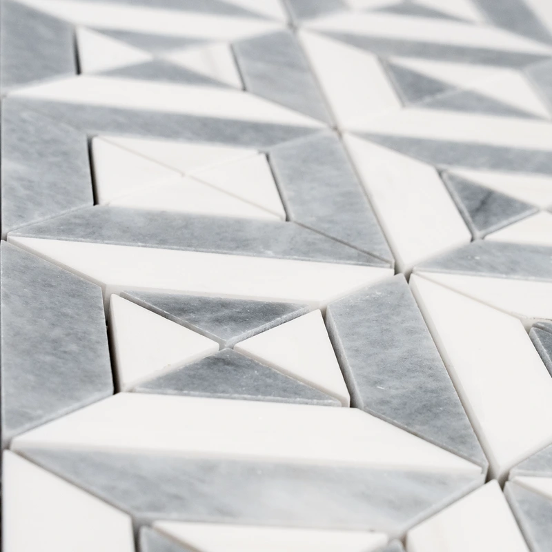 Detailed shot of the geometric pattern with white and gray marble tiles, highlighting the sharp lines and precise cuts.