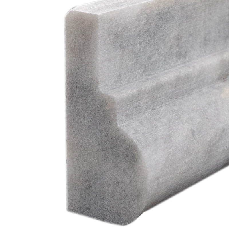 Close-up of Bardiglio marble chair rail corner highlighting rounded edge and dense grey tones