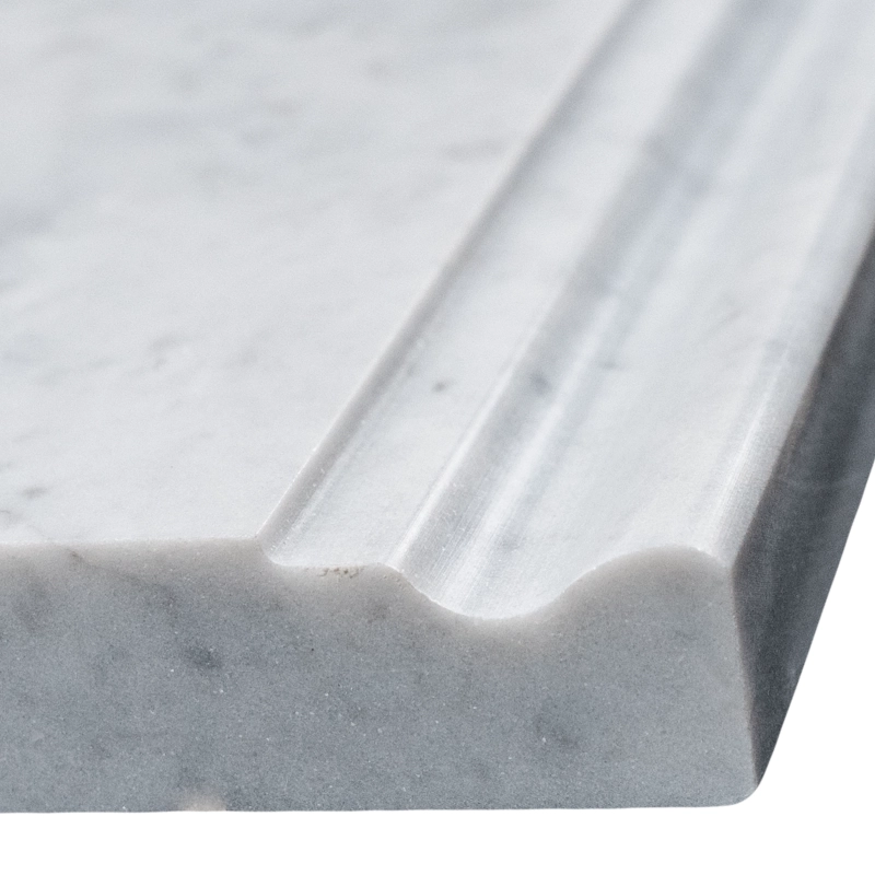 Close-up of Carrara baseboard showcasing the polished beveled detail and classic white background.