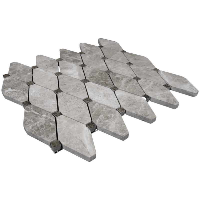 Angled view of polished beige marble diamond mosaic tiles with clipped corners and accent dots.