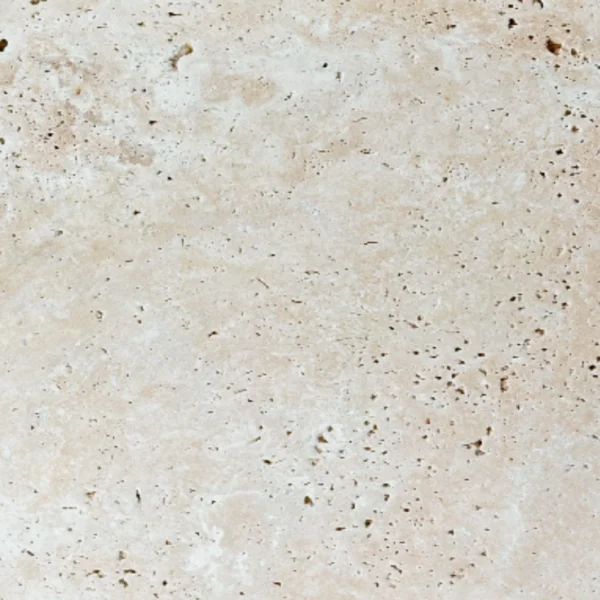 Close-up of Ivory 12x24 Tumbled Travertine Paver showing natural porous texture and soft beige tone – ideal for exterior flooring and patios