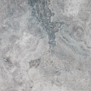 Full view of Charcoal 24"x24" Tumbled Travertine Paver featuring soft grey tones, cloudy patterns, and a rustic tumbled finish for outdoor use.