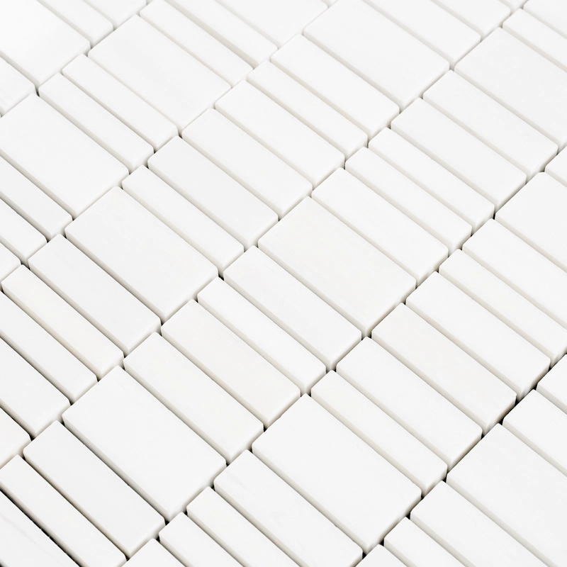 Close-up at an angle showing the polished white dolomite strips with subtle veining and tight grout joints.