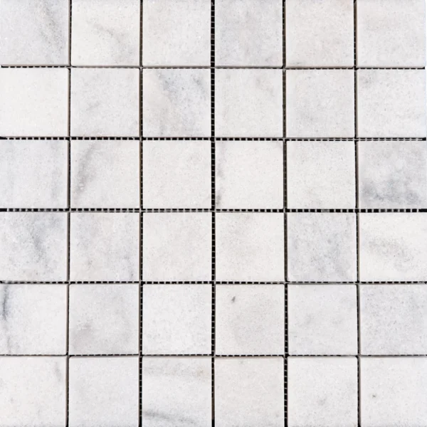 Close-up of Milas White 2x2 polished marble mosaic sheet, highlighting the reflective polished finish and natural white and gray variations.